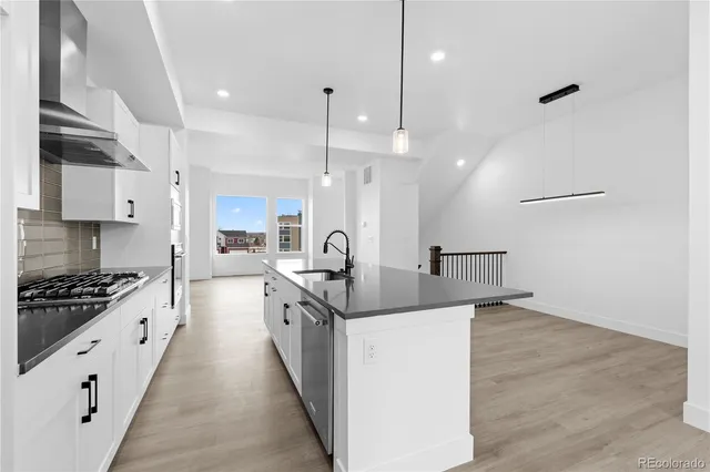 a kitchen with stainless steel appliances a stove sink and cabinets