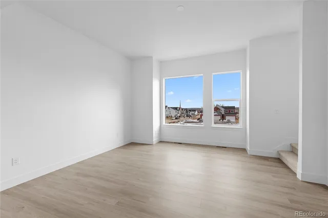 a view of a room with wooden floor and a window