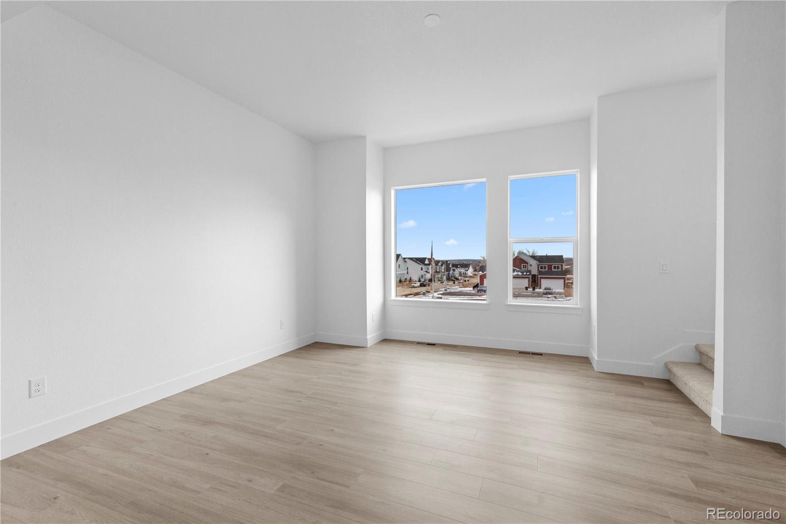 14281 Currant Street Broomfield, CO 80020 - Photo 17 of 23 a view of a room with wooden floor and a window