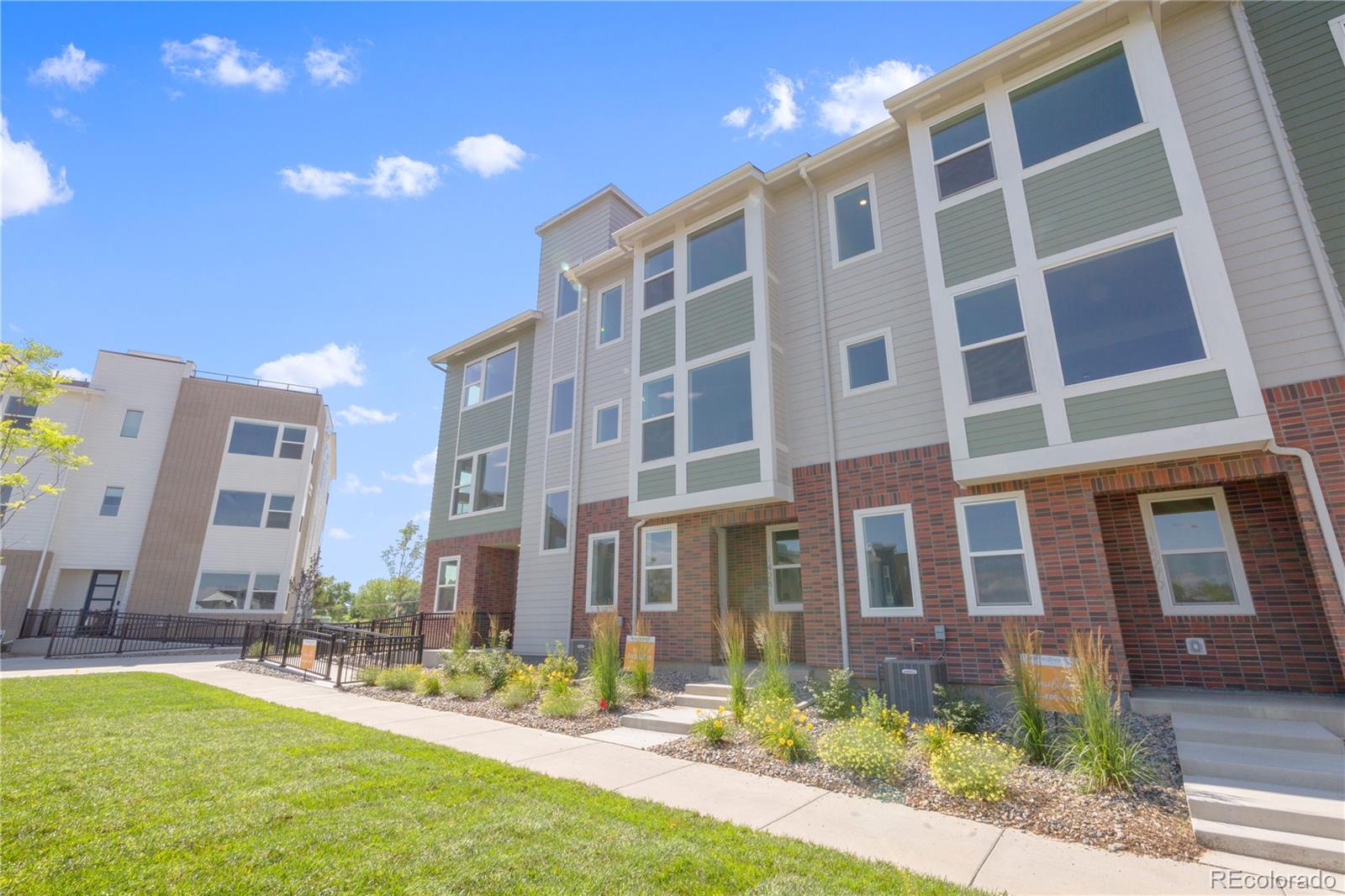 14281 Currant Street Broomfield, CO 80020 - Photo 2 of 23 a front view of a building with a garden