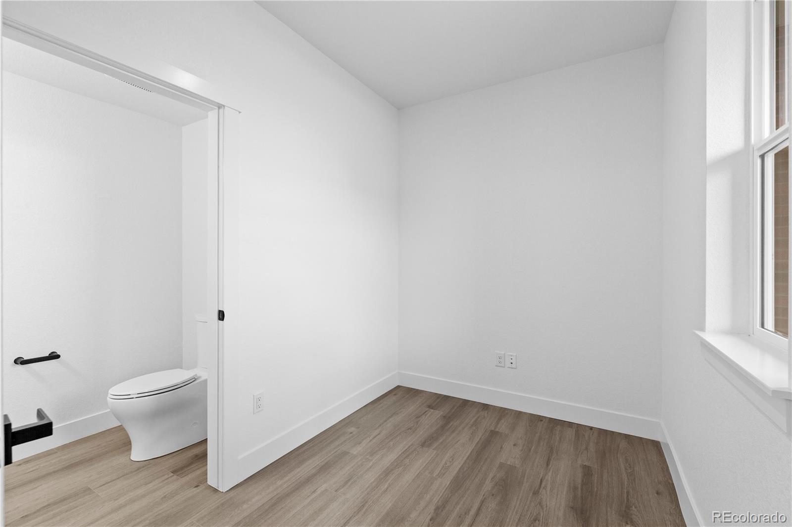 14281 Currant Street Broomfield, CO 80020 - Photo 8 of 23 a view of room with window and wooden floor
