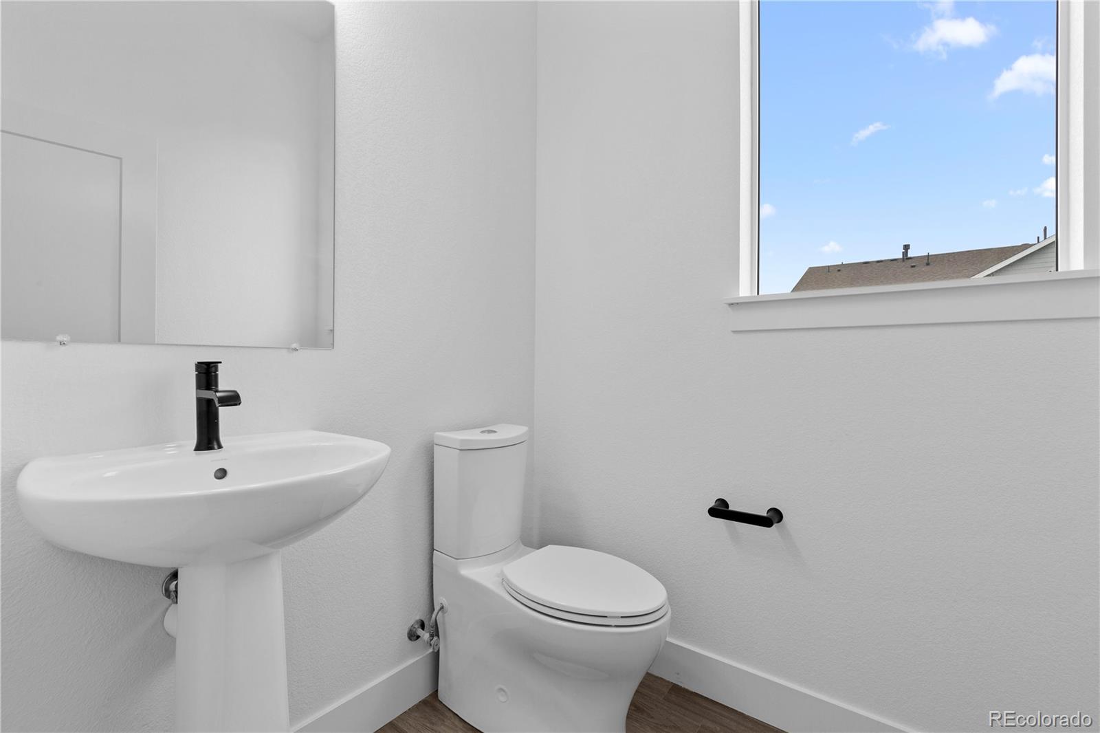 14281 Currant Street Broomfield, CO 80020 - Photo 10 of 23 a bathroom with a sink a toilet and a mirror