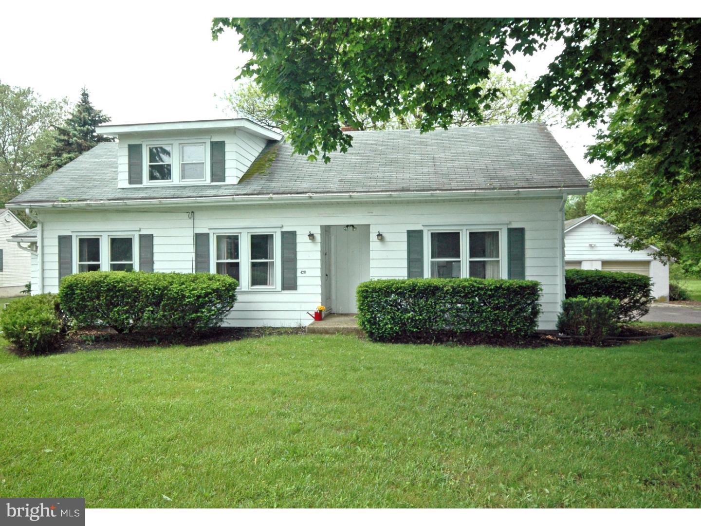 4211 Bridgeboro Road Moorestown, NJ 08057 - Photo 2 of 25 a front view of a house with a yard