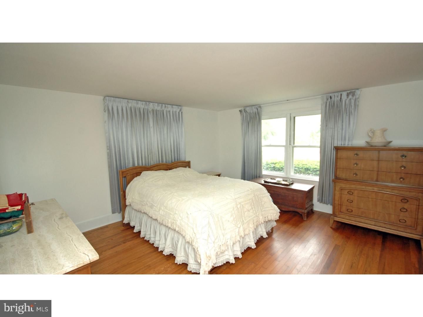 4211 Bridgeboro Road Moorestown, NJ 08057 - Photo 18 of 25 a living room with a bed and dresser with wooden floor