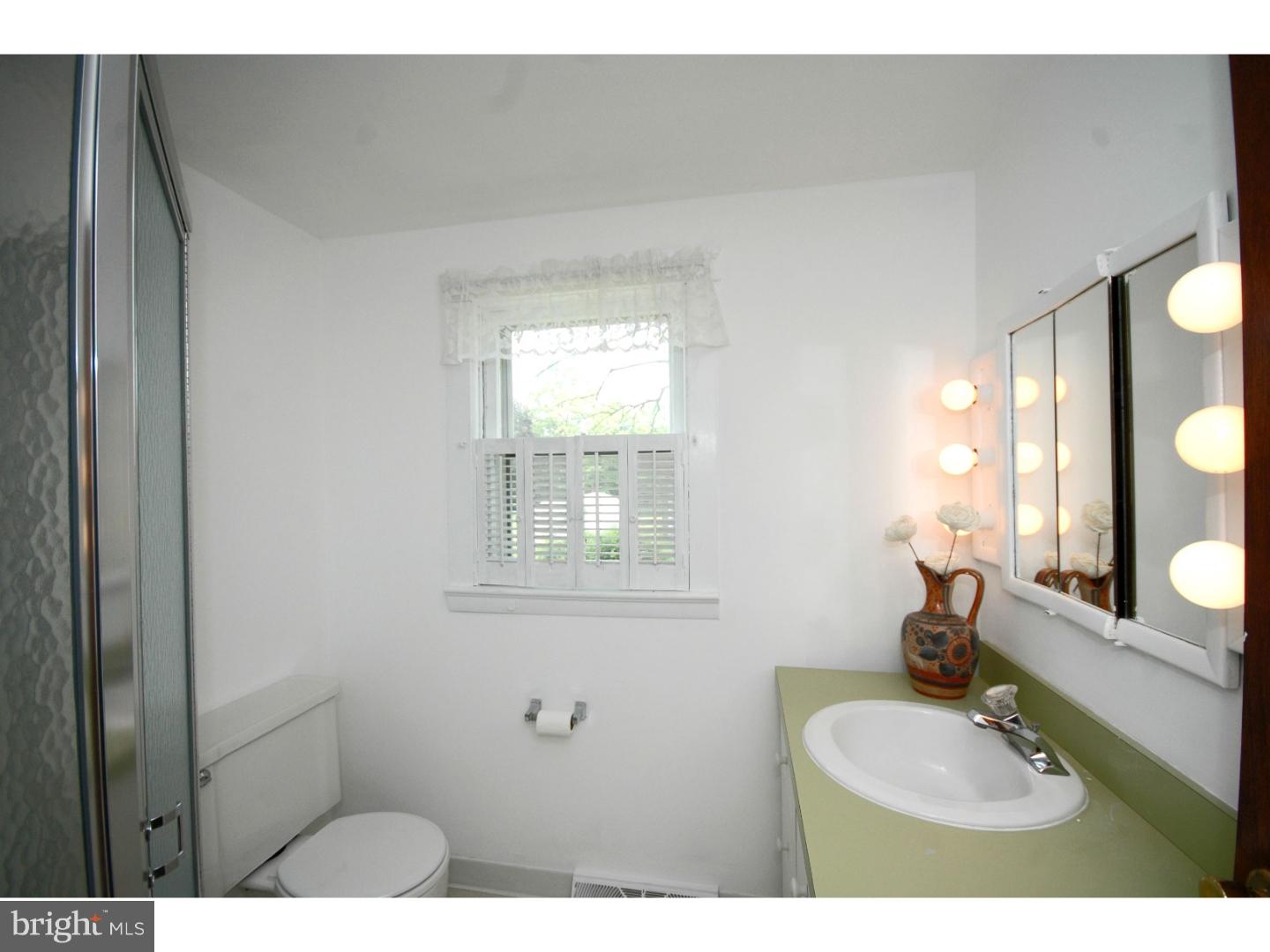 4211 Bridgeboro Road Moorestown, NJ 08057 - Photo 20 of 25 a bathroom with a sink and a mirror