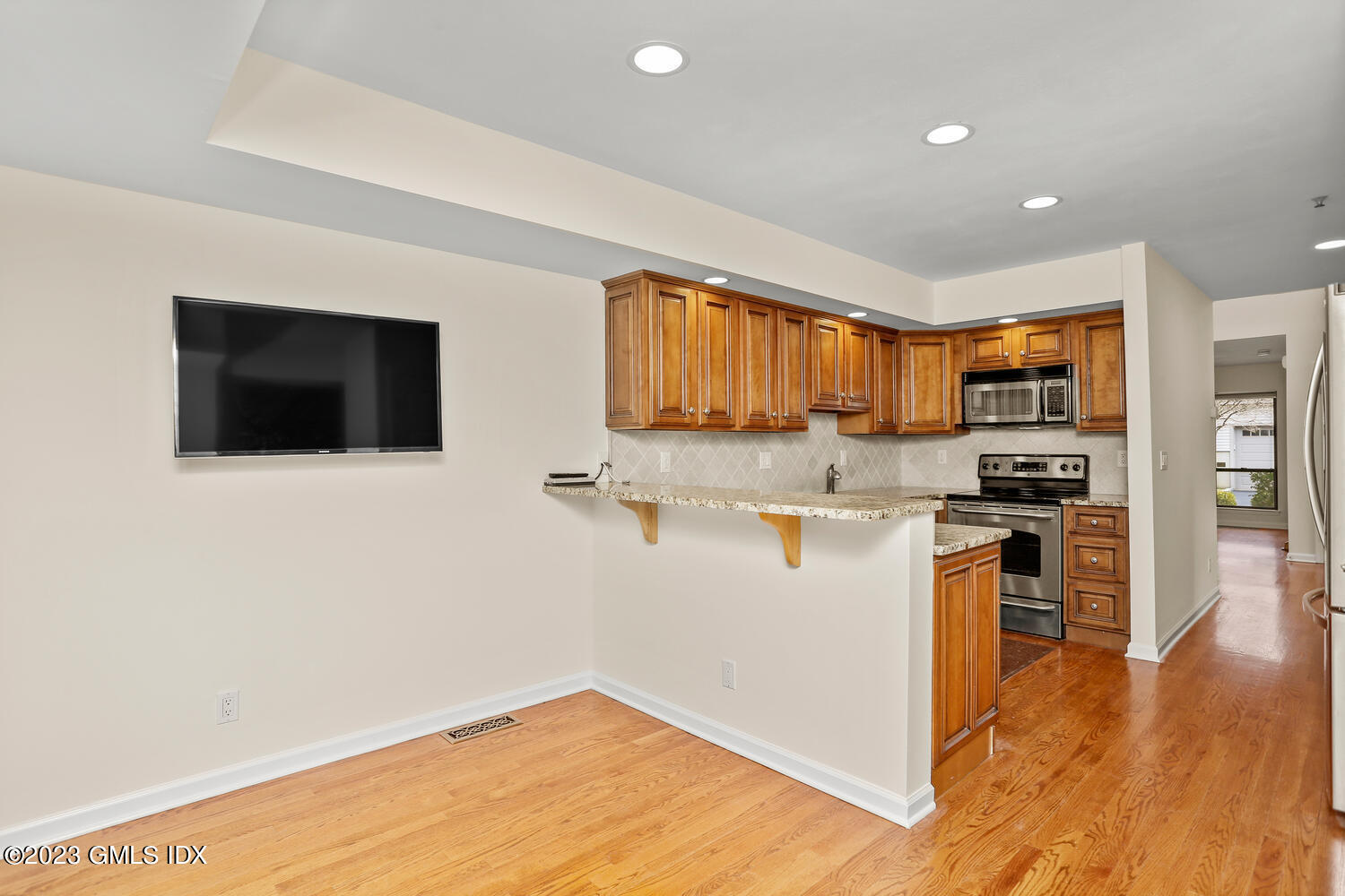 500 River Road, Unit 5 Cos Cob, CT 06807 - Photo 6 of 30 a kitchen with stainless steel appliances granite countertop a stove a sink and a microwave