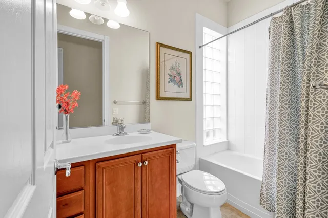 a bedroom with two beds and a chandelier
