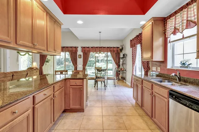 a large kitchen with lots of counter top space and stainless steel appliances