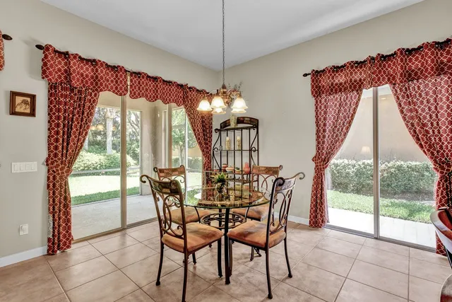 a view of a dining room with furniture large windows and wooden floor