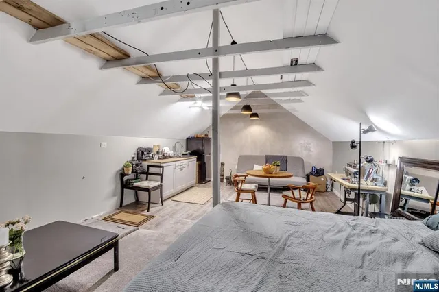 an aerial view of residential house with outdoor space and trees all around