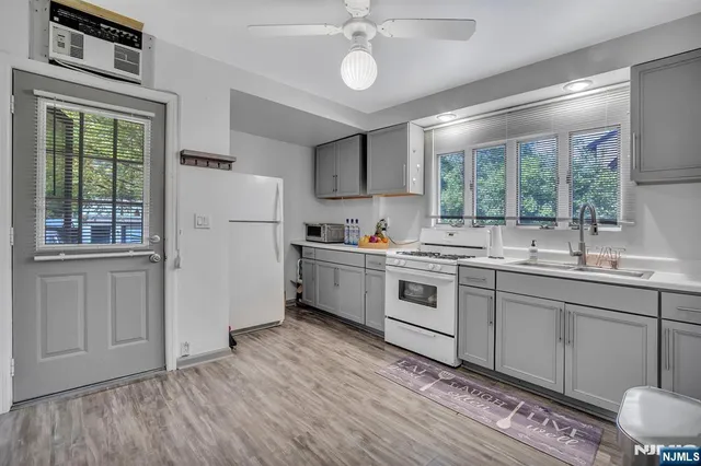 a kitchen with a sink cabinets and window