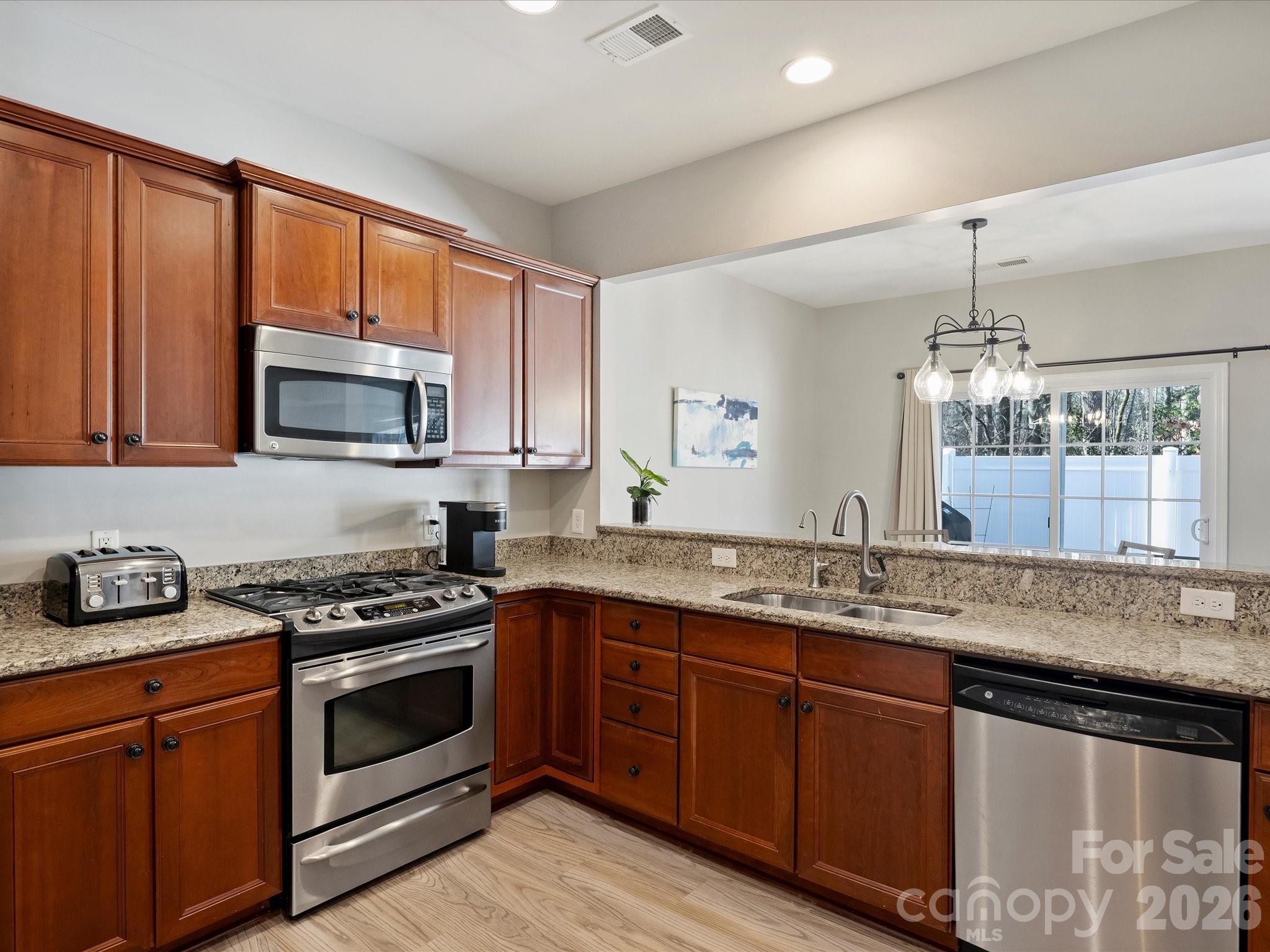 15544 Canmore Street Charlotte, NC 28277 - Photo 16 of 36 a kitchen with granite countertop a sink stove and microwave