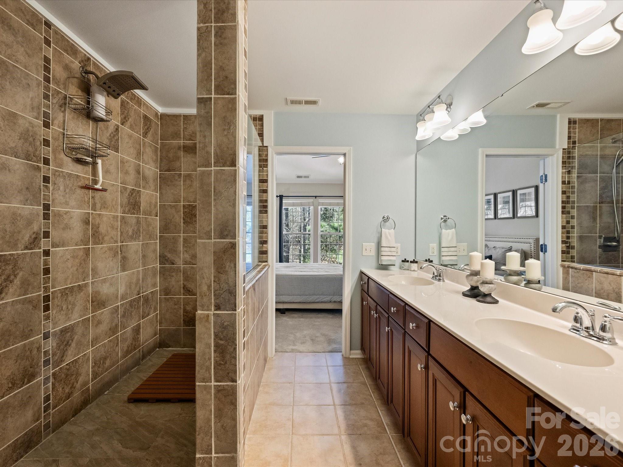 15544 Canmore Street Charlotte, NC 28277 - Photo 26 of 36 a spacious bathroom with a double vanity sink a mirror and a shower