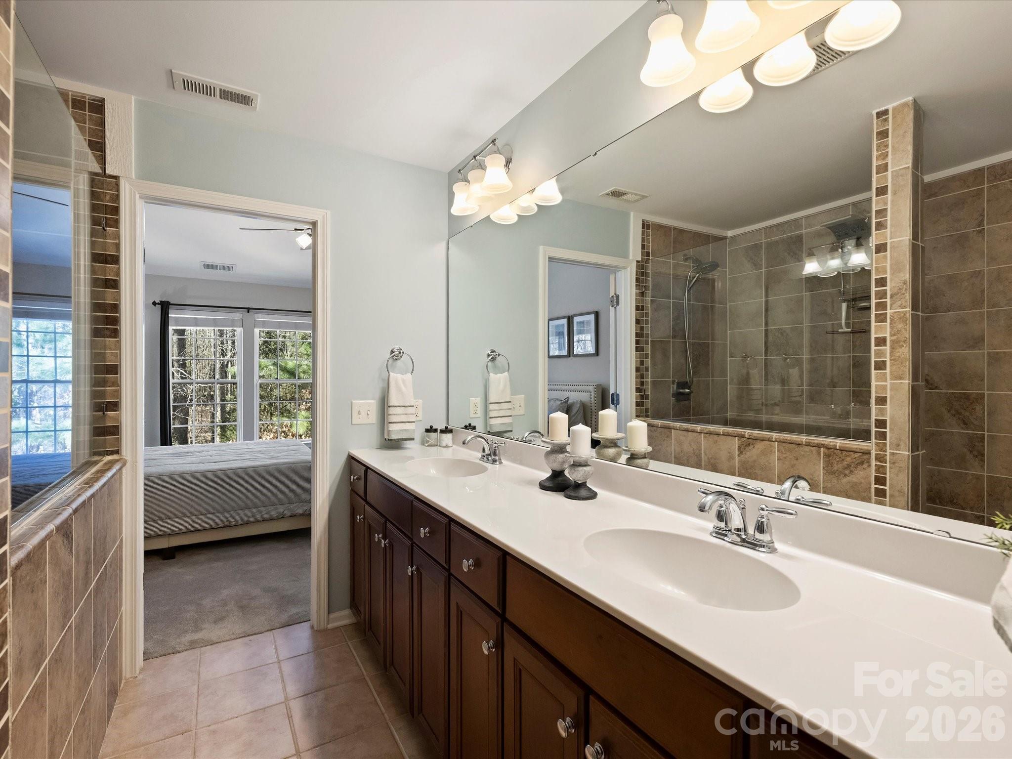 15544 Canmore Street Charlotte, NC 28277 - Photo 27 of 36 a bathroom with a tub a sink double vanity and a mirror