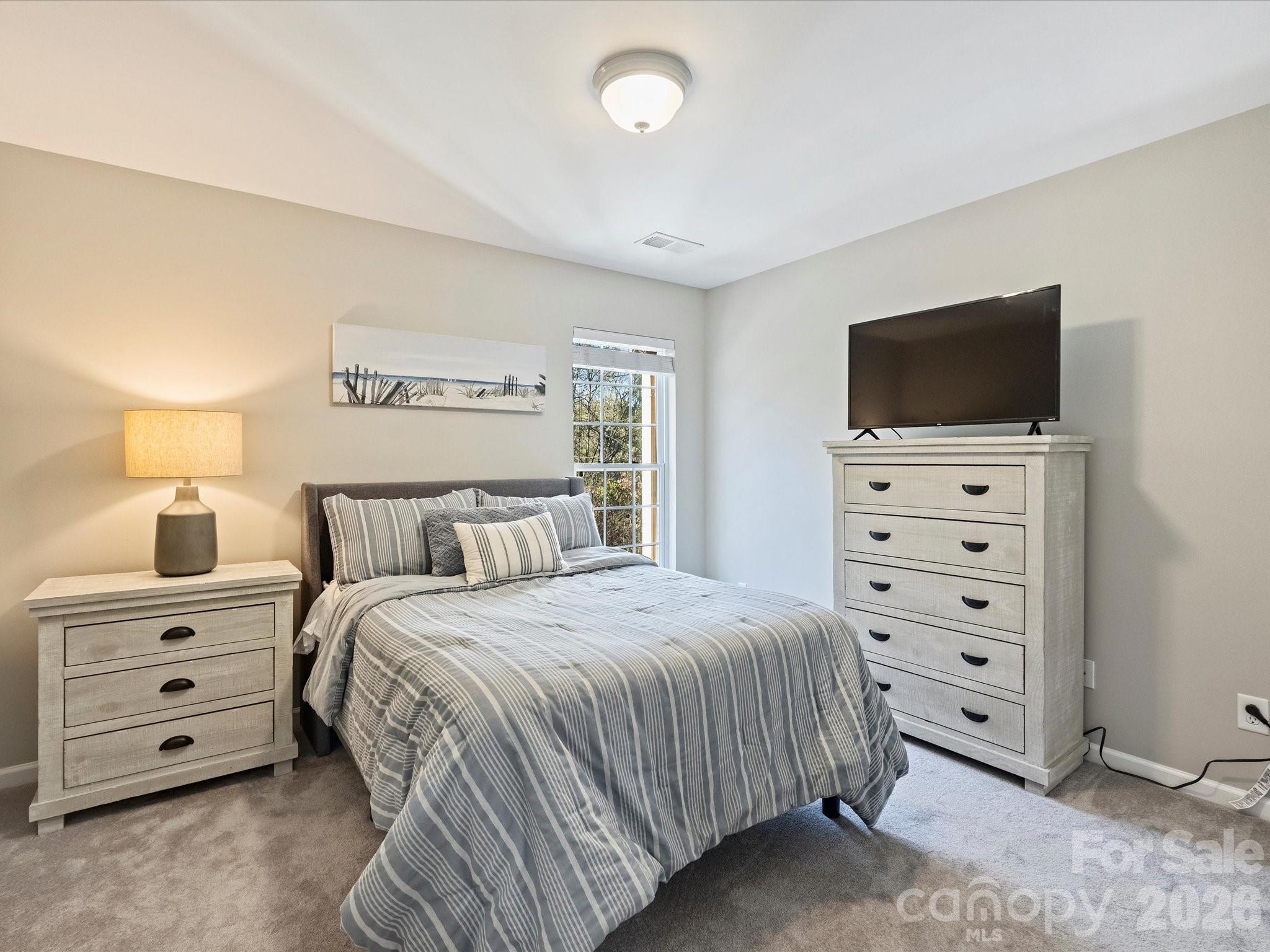 15544 Canmore Street Charlotte, NC 28277 - Photo 30 of 36 a bedroom with a bed and a television