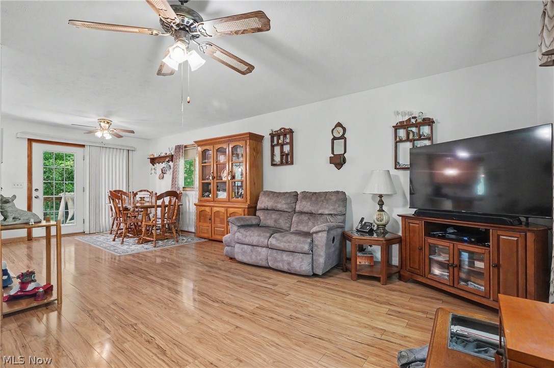4250 Herr Fieldhouse Road Southington, OH 44470 - Photo 7 of 50 Spacious living area featuring wood-finish flooring, white walls, and a ceiling fan with light fixture