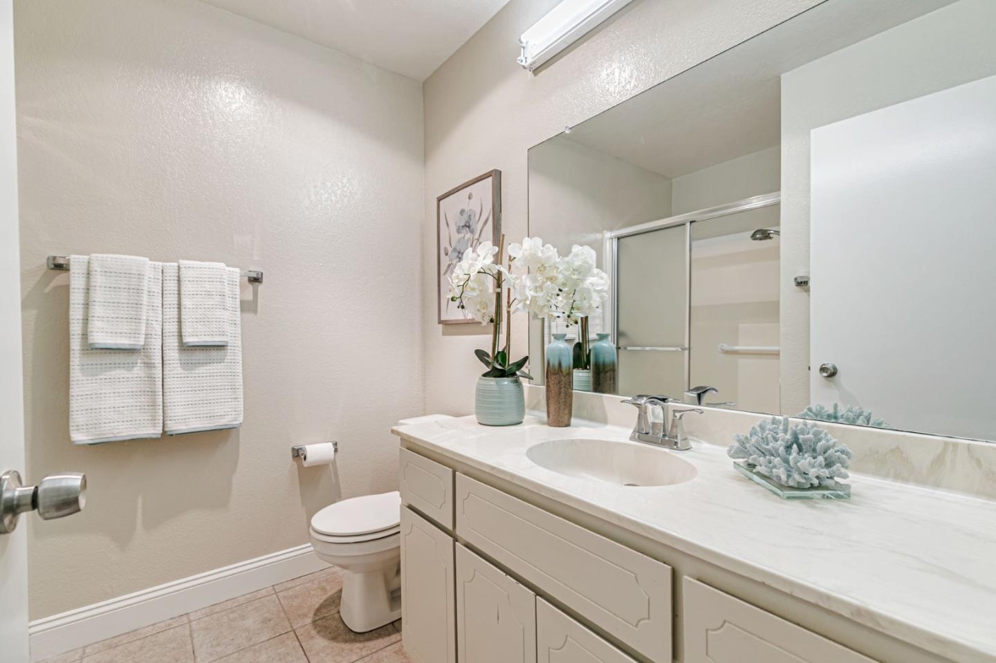 6200 Gerdts Drive San Jose, CA 95135 - Photo 24 of 39 a bathroom with a granite countertop sink a toilet and a mirror