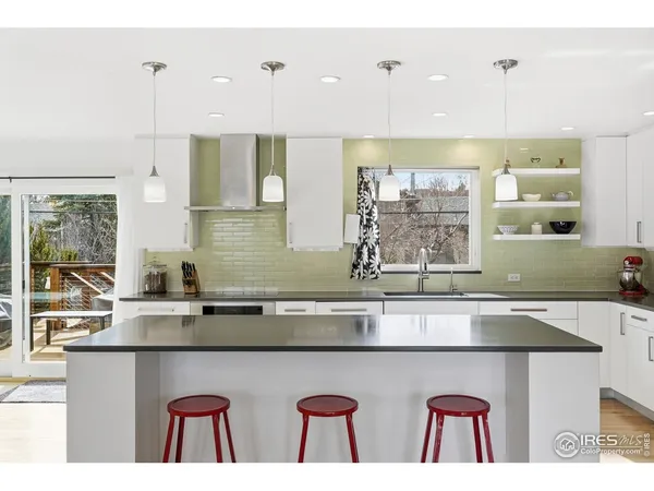 a kitchen with a sink a counter space and cabinets