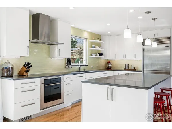 a kitchen with stainless steel appliances granite countertop a sink stove and cabinets
