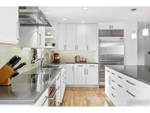 a kitchen with granite countertop a sink and cabinets