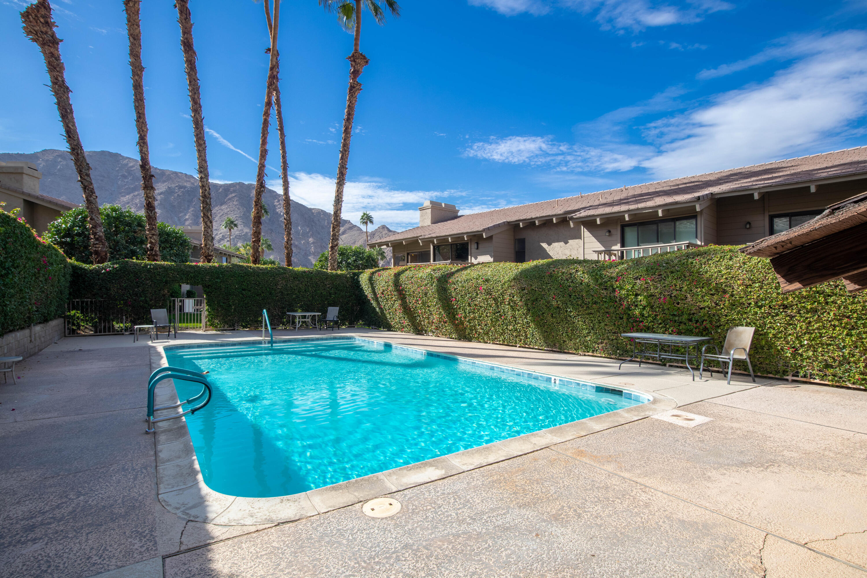 46560 Arapahoe Circle, Unit B Indian Wells, CA 92210 - Photo 17 of 17 a view of a swimming pool with a patio and a yard