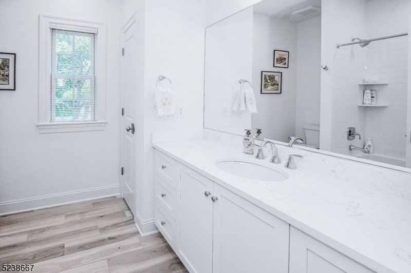 29 Euclid Avenue, Unit 203 Summit, NJ 07901 - Photo 12 of 25 a bathroom with a sink and a mirror