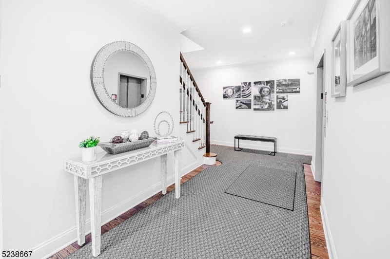 29 Euclid Avenue, Unit 203 Summit, NJ 07901 - Photo 18 of 25 a view of living room with furniture and a mirror