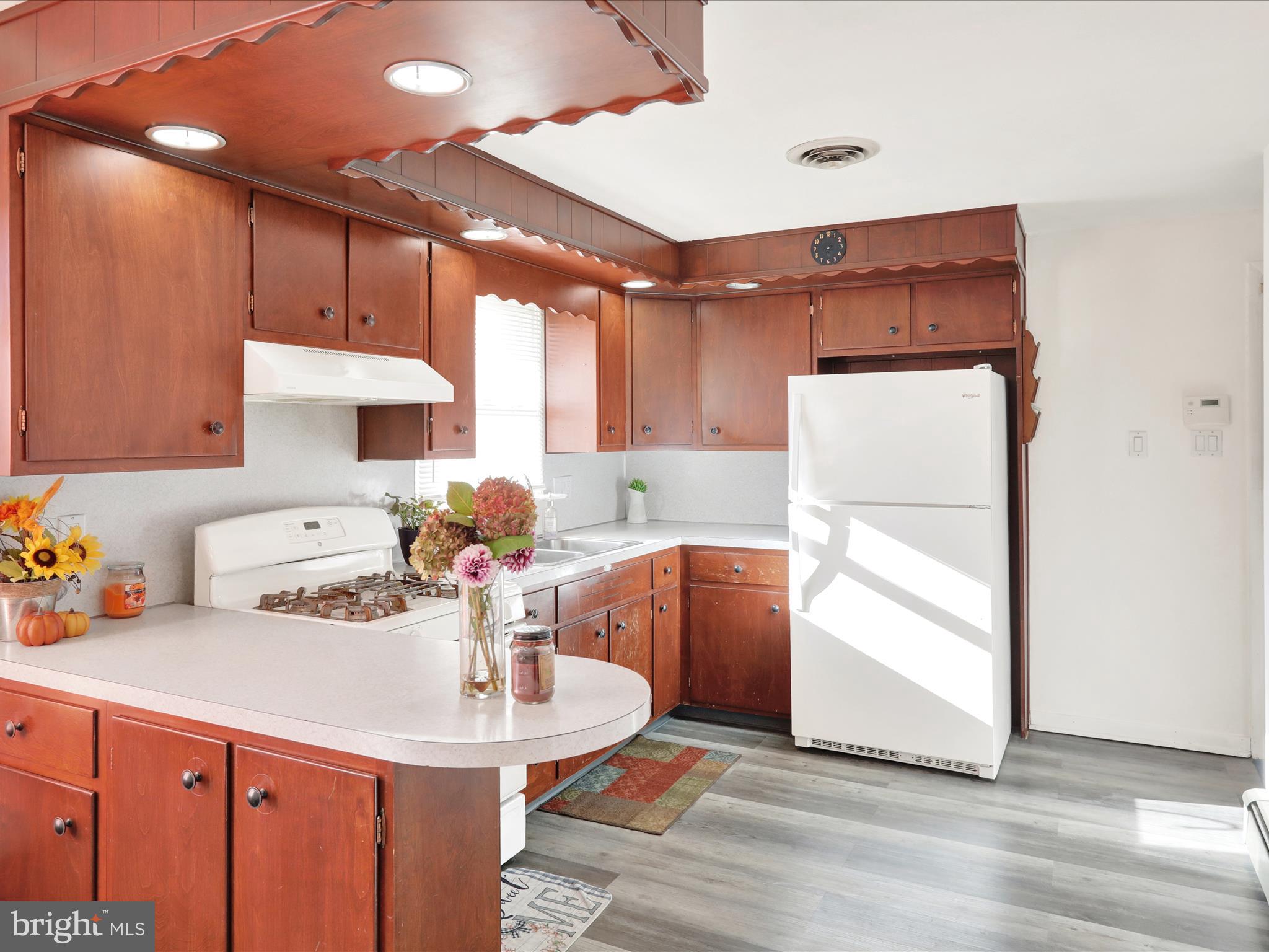 3908 Reading Crest Avenue Reading, PA 19605 - Photo 11 of 34 a kitchen with stainless steel appliances a sink cabinets and wooden floor