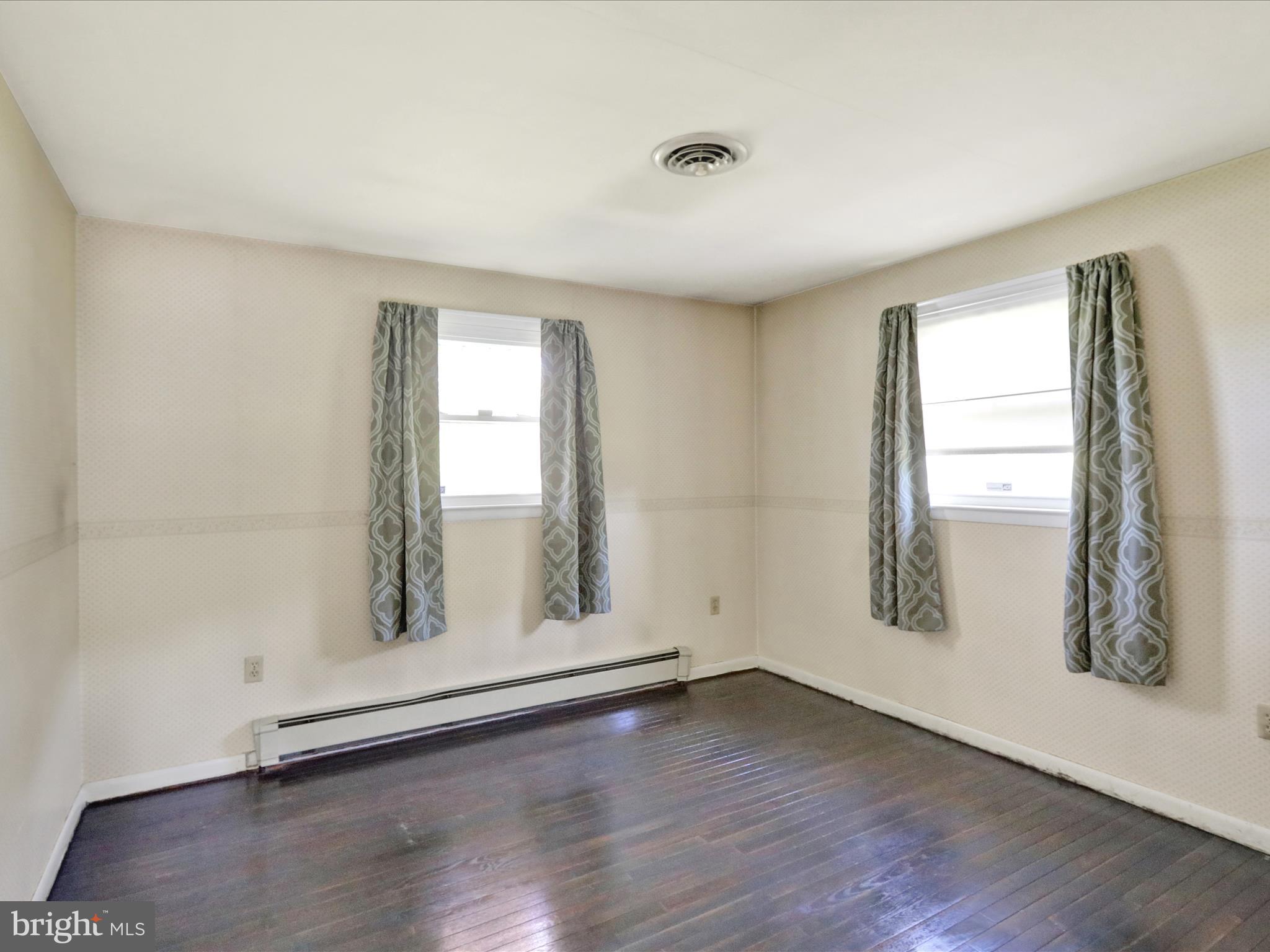 3908 Reading Crest Avenue Reading, PA 19605 - Photo 21 of 34 an empty room with wooden floor and windows