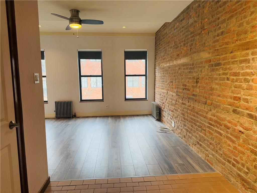 196 23rd Street Brooklyn, NY 11232 - Photo 7 of 11 wooden floor in an empty room with a window