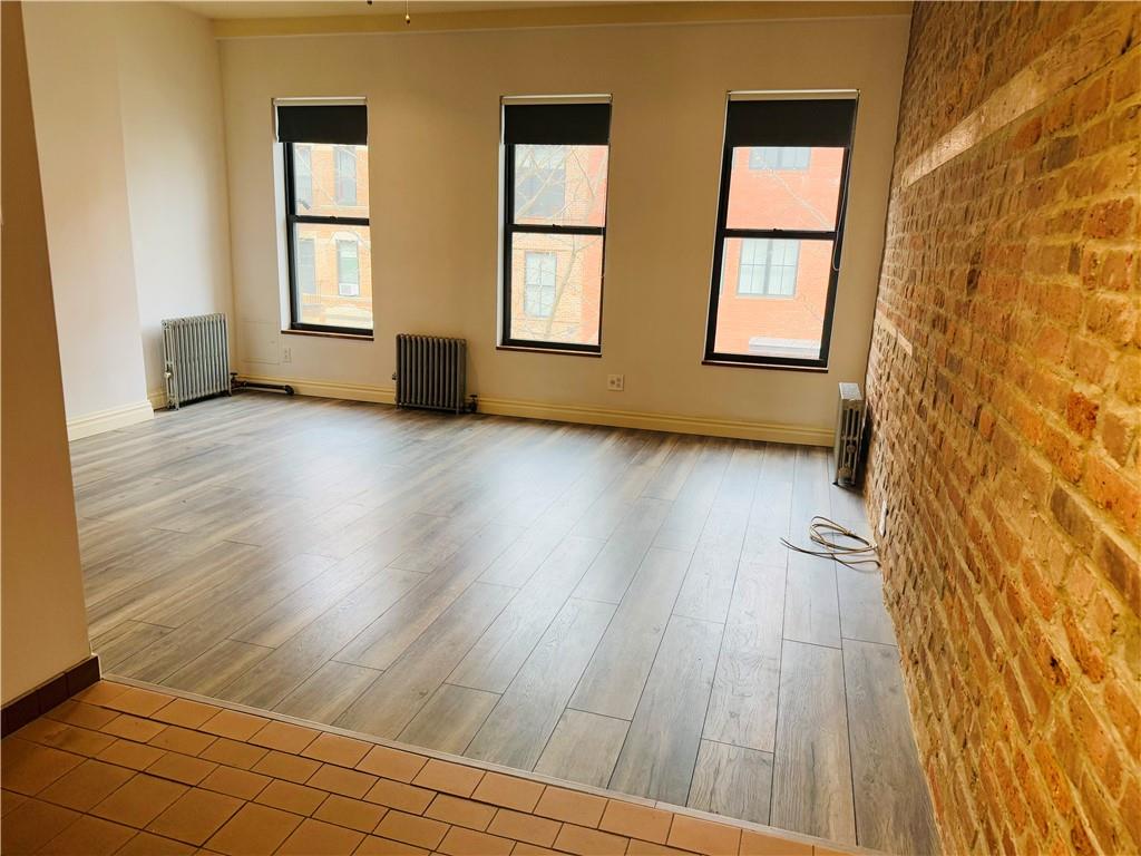 196 23rd Street Brooklyn, NY 11232 - Photo 8 of 11 a view of empty room with wooden floor and fan