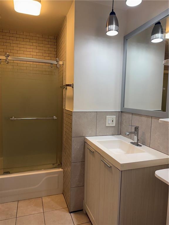 196 23rd Street Brooklyn, NY 11232 - Photo 9 of 11 a bathroom with a sink a toilet and shower