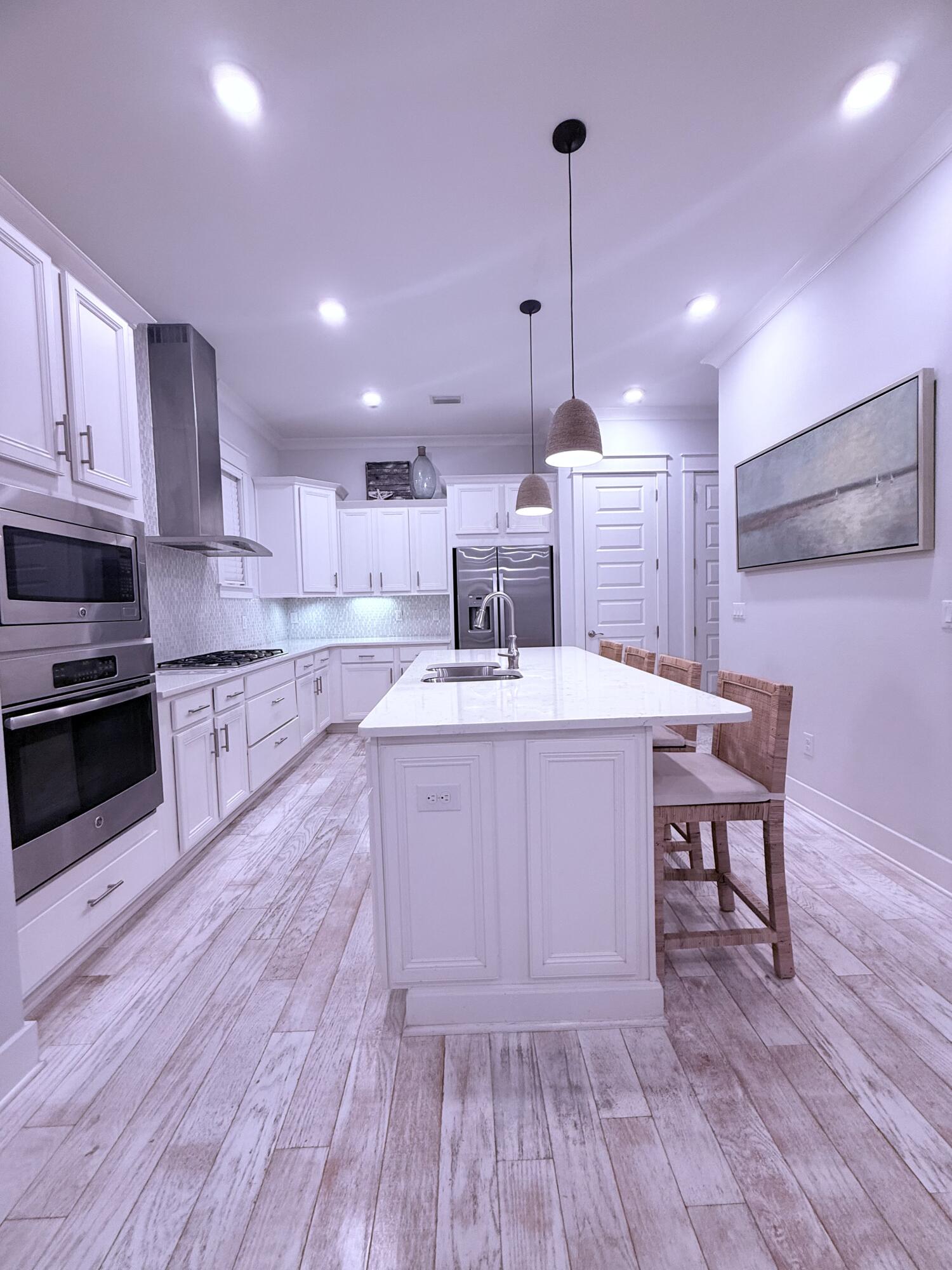 Undisclosed Address Inlet Beach, FL 32461 - Photo 11 of 11 a kitchen with a sink a stove and chairs