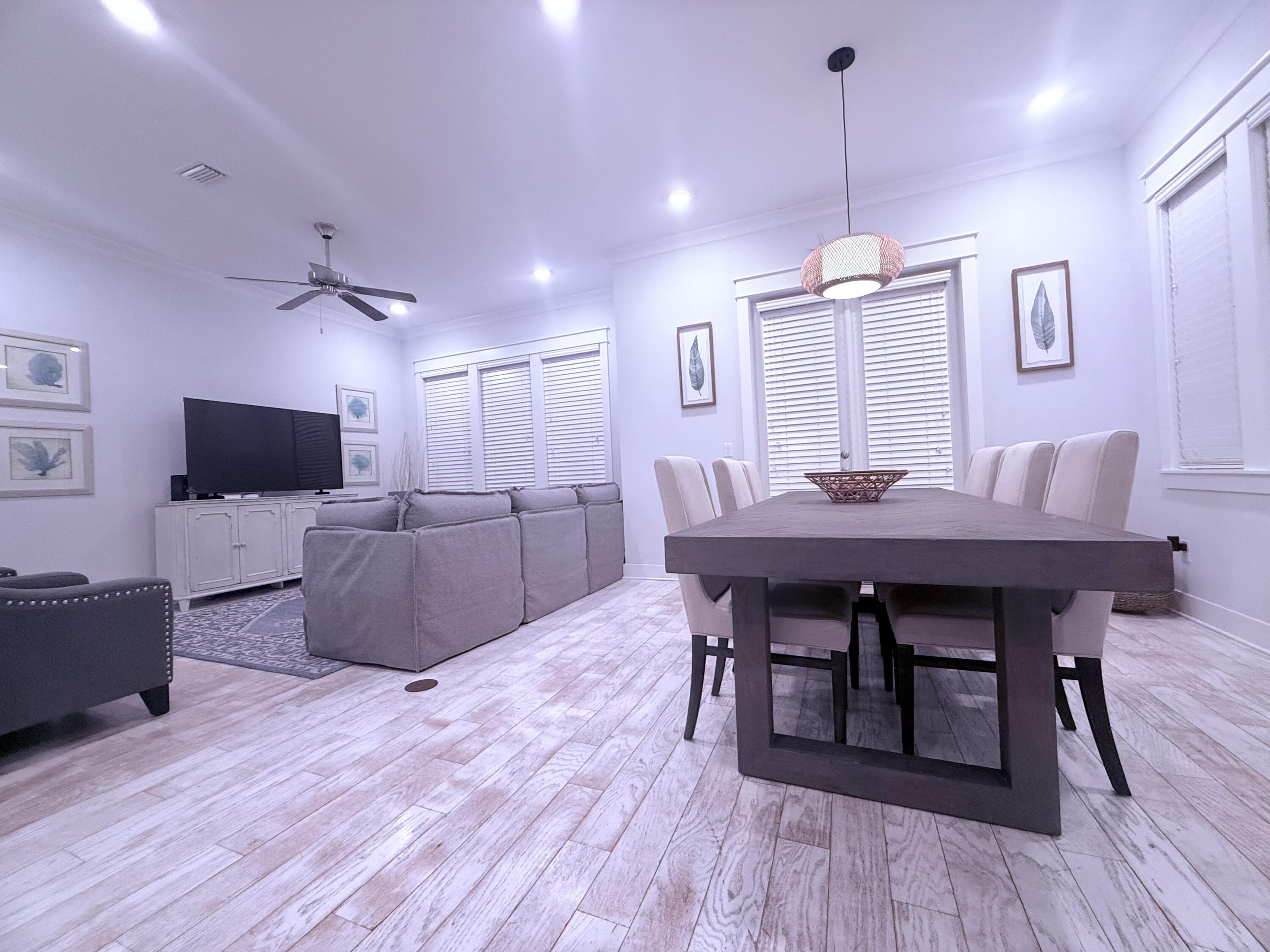 Undisclosed Address Inlet Beach, FL 32461 - Photo 4 of 11 a view of a dining room with furniture wooden floor and a chandelier
