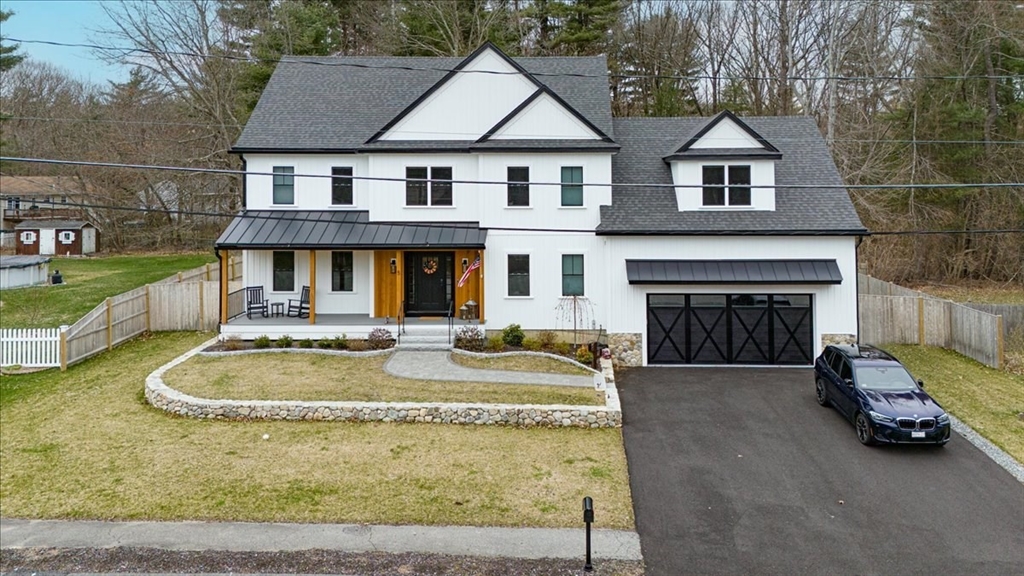 a front view of a house with a yard fire pit and outdoor seating