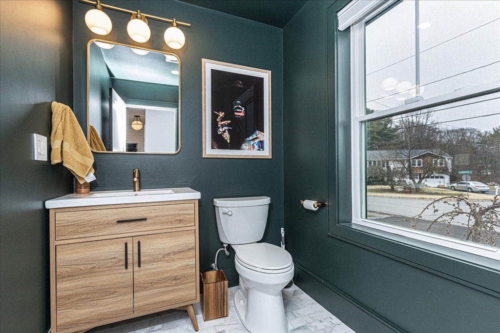 5 Brookside Lane Burlington, MA 01803 - Photo 16 of 42 a bathroom with a toilet a sink a vanity and mirror