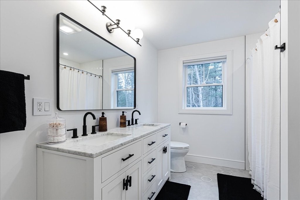 5 Brookside Lane Burlington, MA 01803 - Photo 25 of 42 a bathroom with a double vanity sink toilet and mirror
