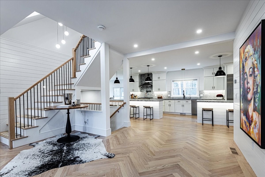 5 Brookside Lane Burlington, MA 01803 - Photo 5 of 42 a living room with stainless steel appliances kitchen island granite countertop a table chairs and a view of living room
