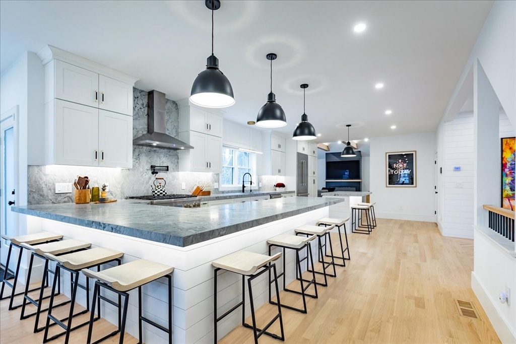 5 Brookside Lane Burlington, MA 01803 - Photo 8 of 42 a kitchen with stainless steel appliances kitchen island granite countertop a table chairs sink and cabinets