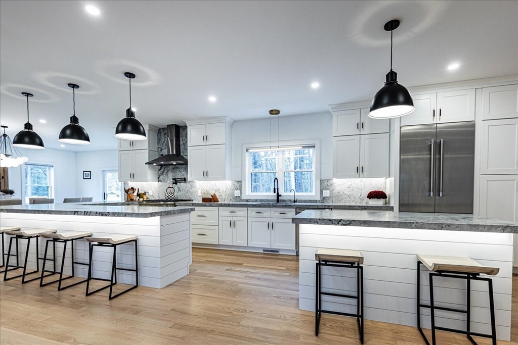 5 Brookside Lane Burlington, MA 01803 - Photo 9 of 42 a kitchen with stainless steel appliances granite countertop a stove a sink white cabinets and a granite counter tops