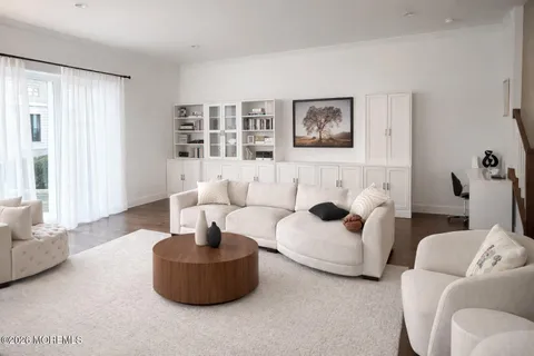 a kitchen with stainless steel appliances granite countertop a table chairs refrigerator and sink