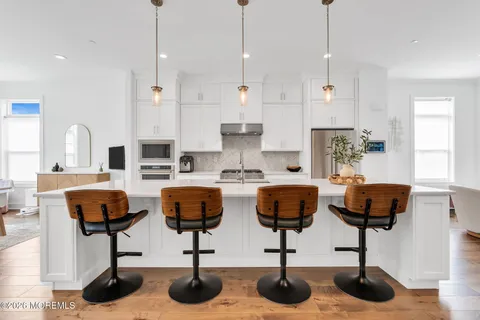 a kitchen with a sink and a potted plant