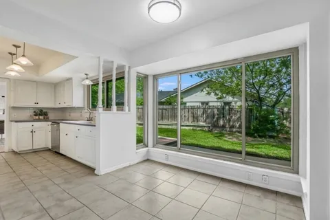 a open kitchen with white cabinets and sink