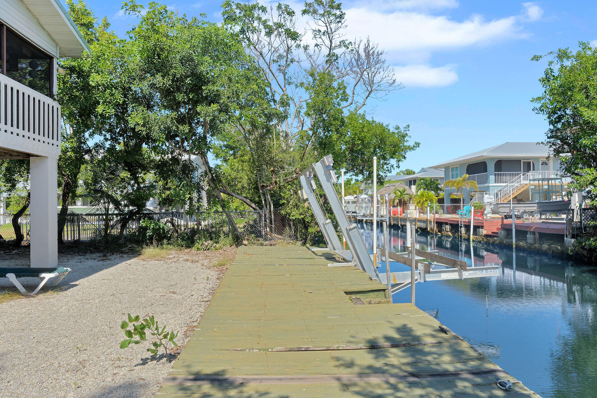 a view of a swimming pool with a patio and a yard