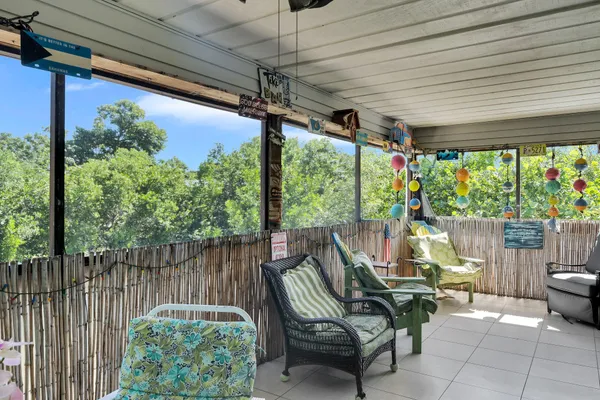 a view of a porch with furniture and a backyard