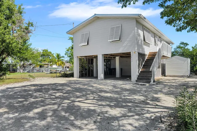 a view of a house with a yard and garage