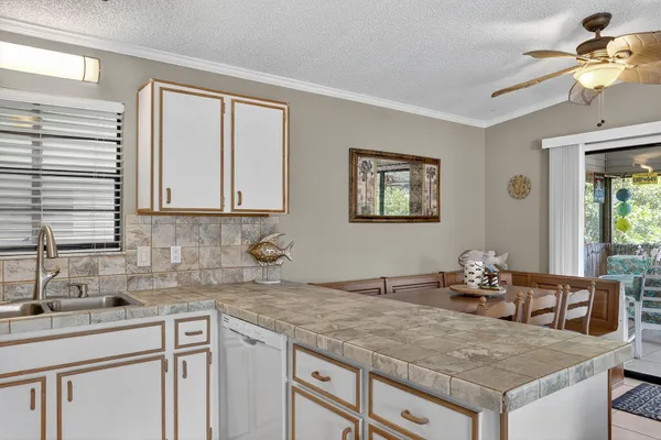 a kitchen with cabinets appliances and a sink