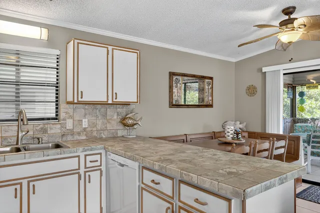 a kitchen with cabinets appliances and a sink