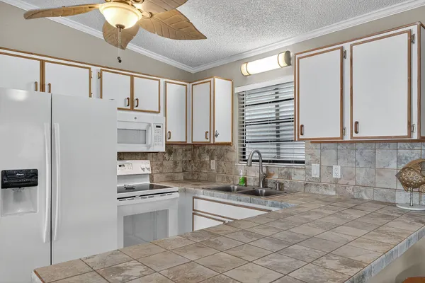 a kitchen with stainless steel appliances a refrigerator sink and cabinets