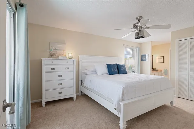a bedroom with a bed and ceiling fan